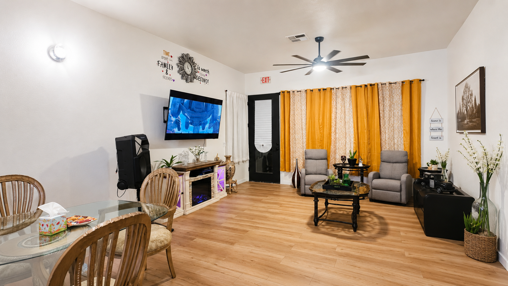 Spacious common lounge with recliners, TV, and warm decor at Apex Senior Living Home